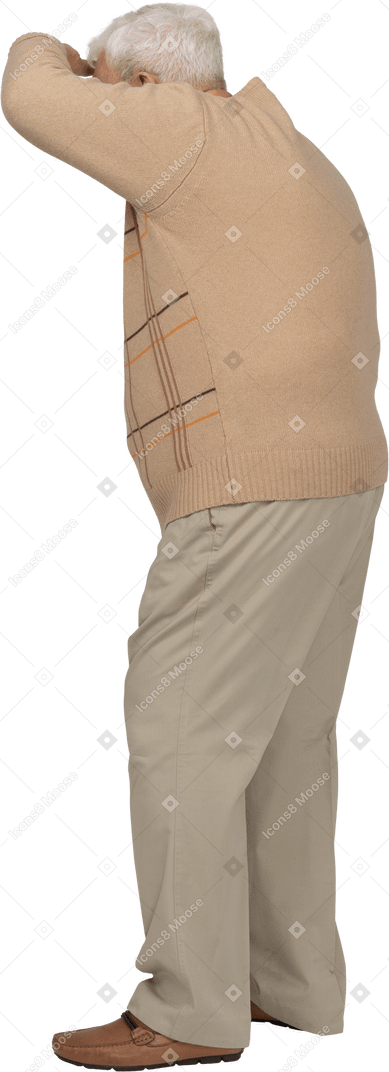 Side view of an old man in casual clothes looking for someone