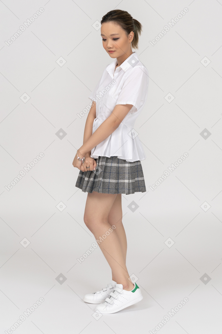 Cheerful young girl holding hands together