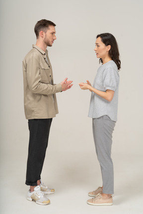 Side view of young couple speaking to each other