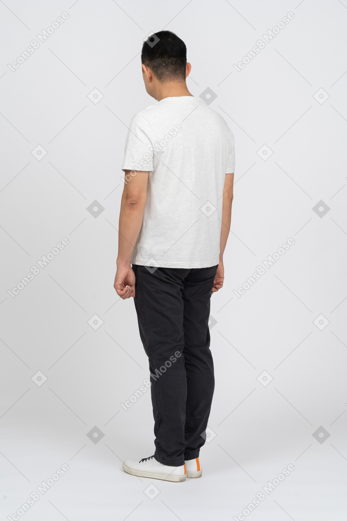 Man in casual clothes standing back to camera