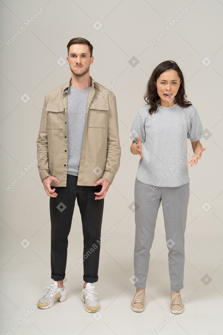 Front view  of young couple being mad and shouting