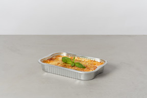 Piece of lasagna in oven pan