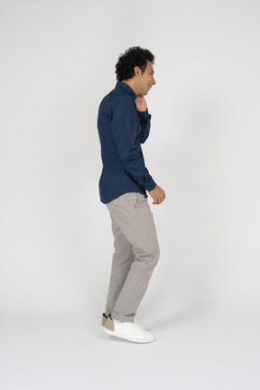 Man in casual clothes standing in profile