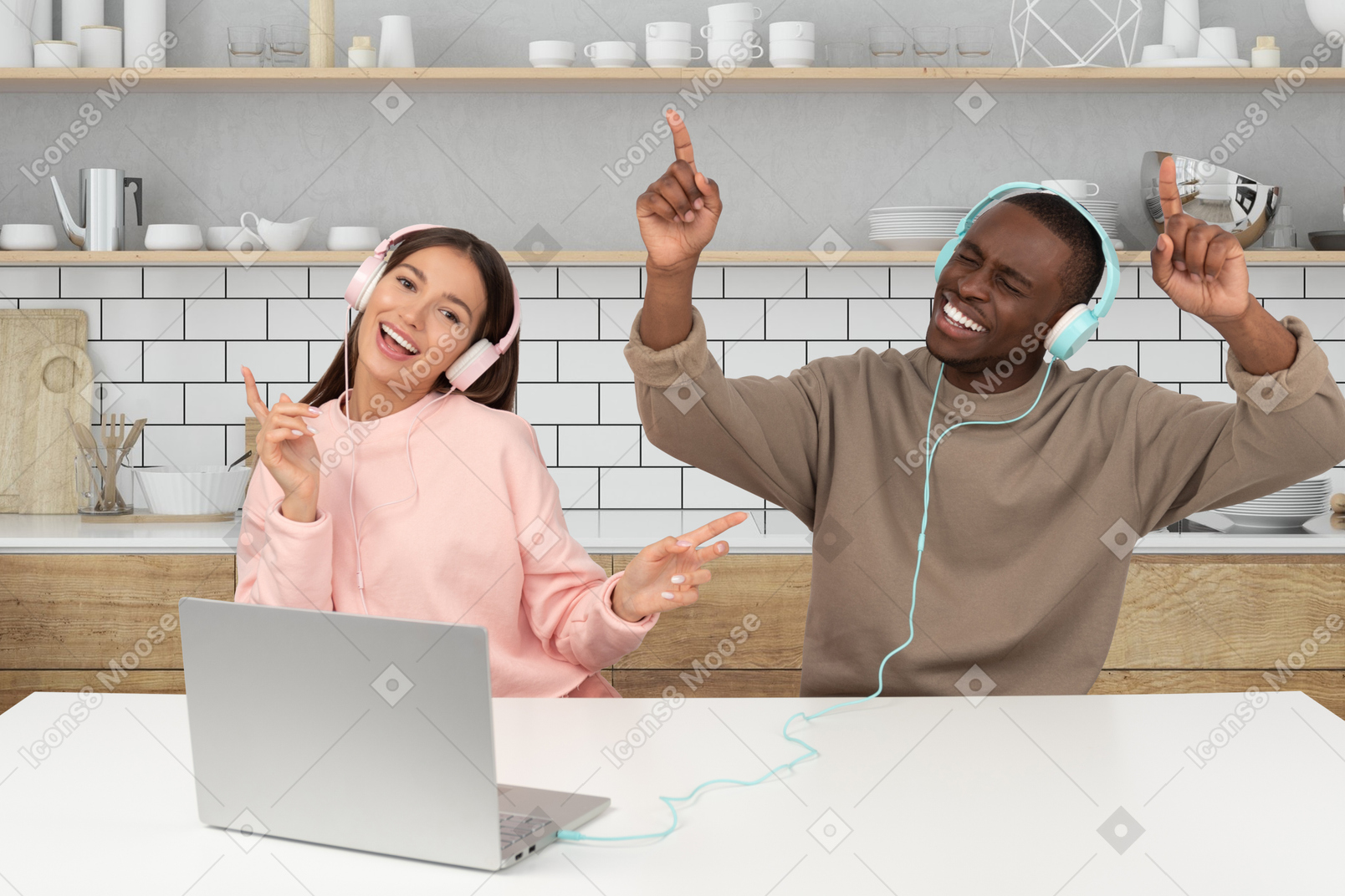 A man and woman listening to music in a kitchen