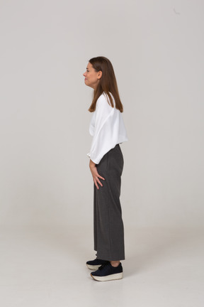 Side view of a smiling young lady in office clothing