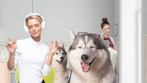 Two women and two husky dogs