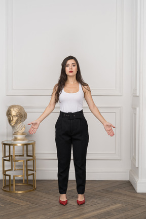 Front view of young businesswoman raising hands