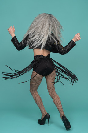 Back view of a drag queen spinning around