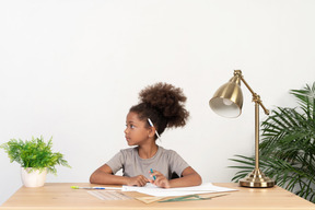 Good looking cute girl with books at the table