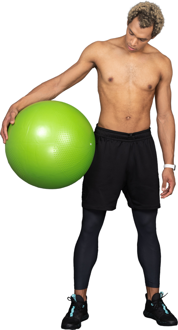 Front view of a shirtless afro man holding a big green gym ball Photo