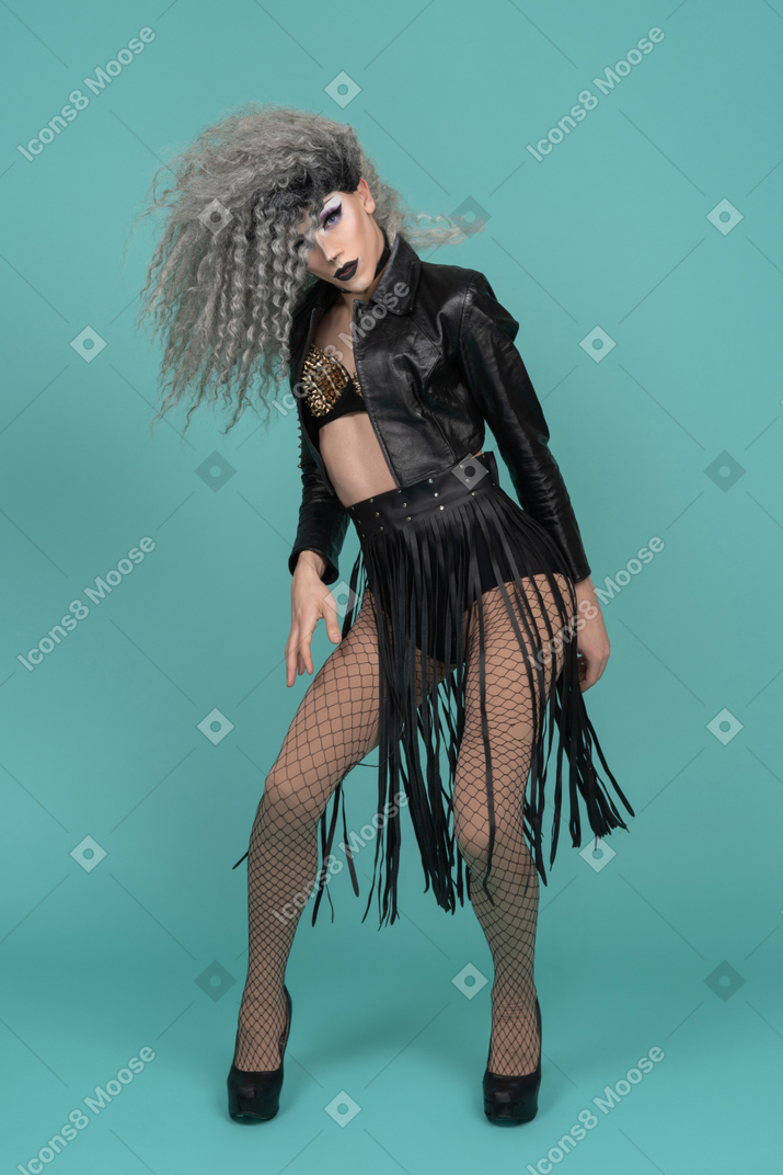 Drag queen in leather jacket posing with messy hair