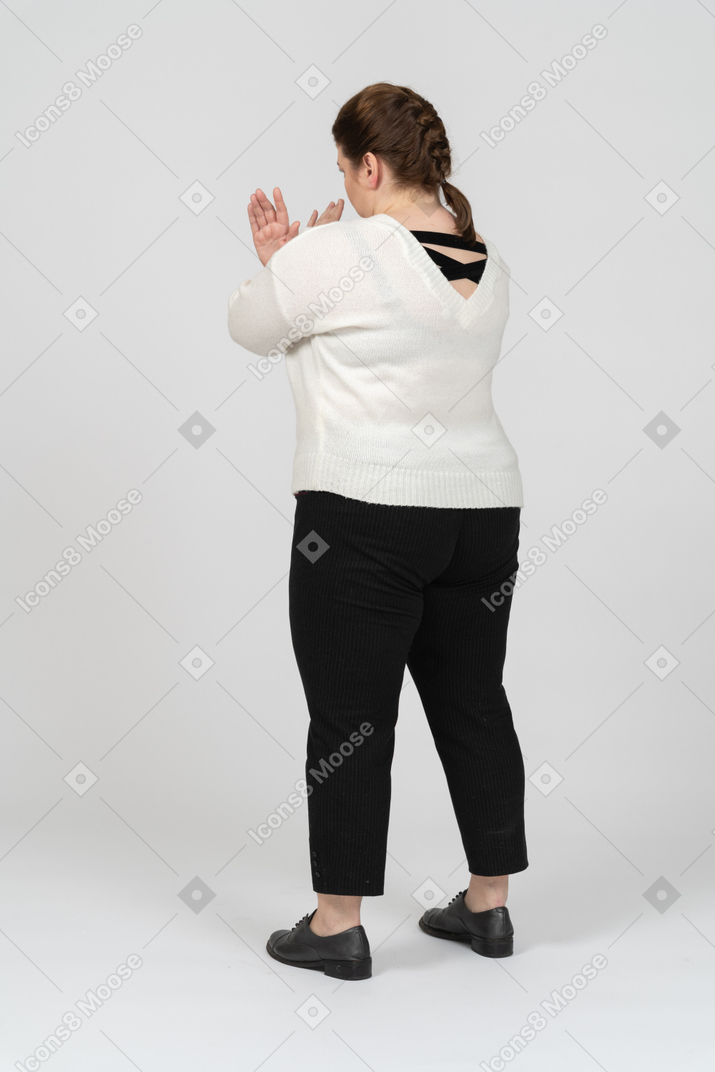 Plump woman in casual clothes crossing arms to say no