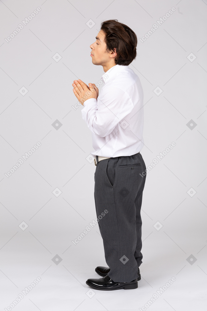 Male office worker praying
