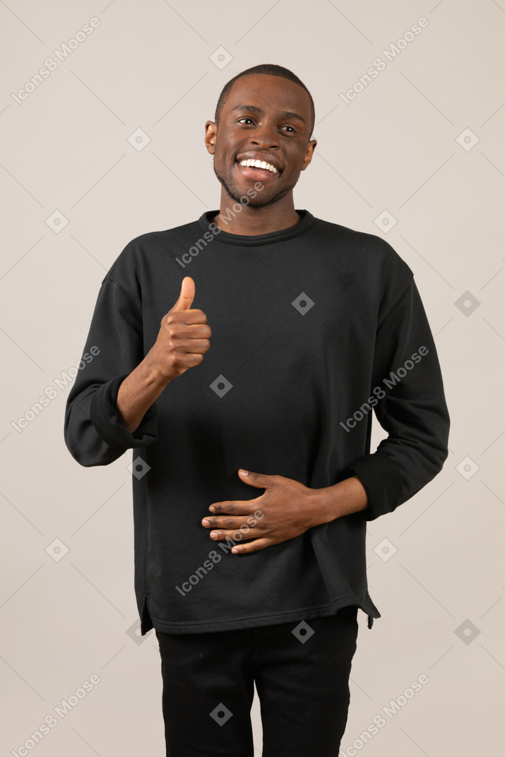 Smiling man with thumbs up looking aside