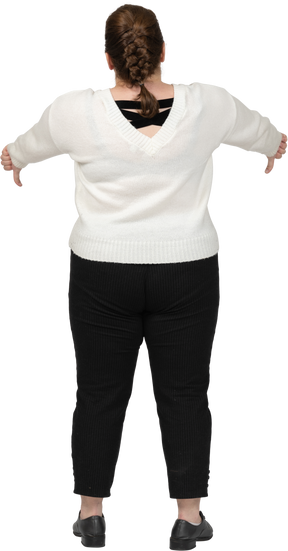 Plus size woman in casual clothes showing thumbs down