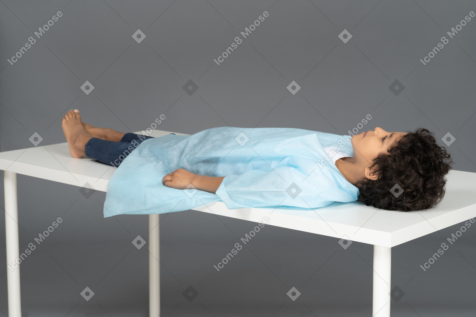 Little boy lying on the table