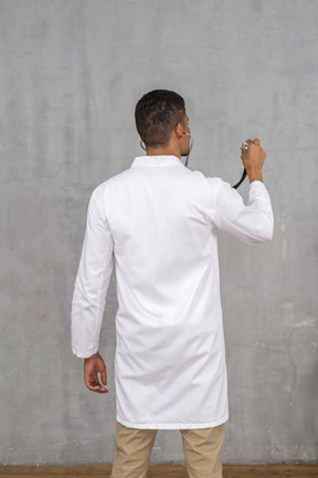 Back view of a male doctor with a stethoscope