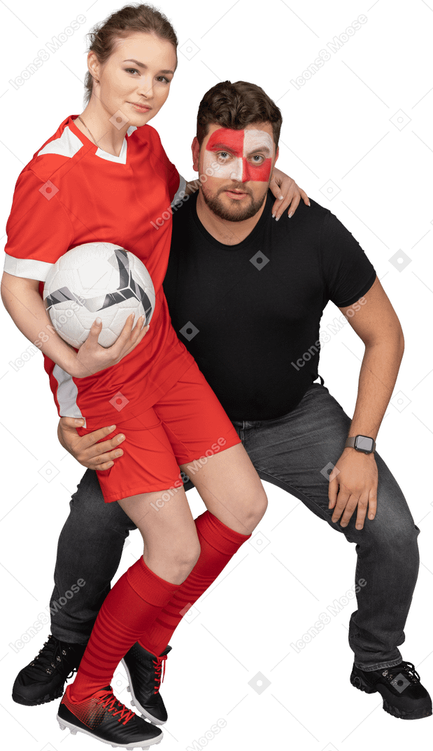 女性のサッカー選手を抱きしめる男性のサッカーファンの正面図