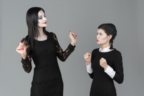 Morticia addams telling something to do to her daughter
