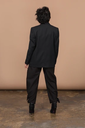 Back view of unrecognizable woman wearing black suit