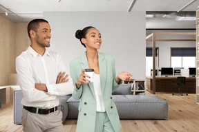 A man and a woman standing in an office