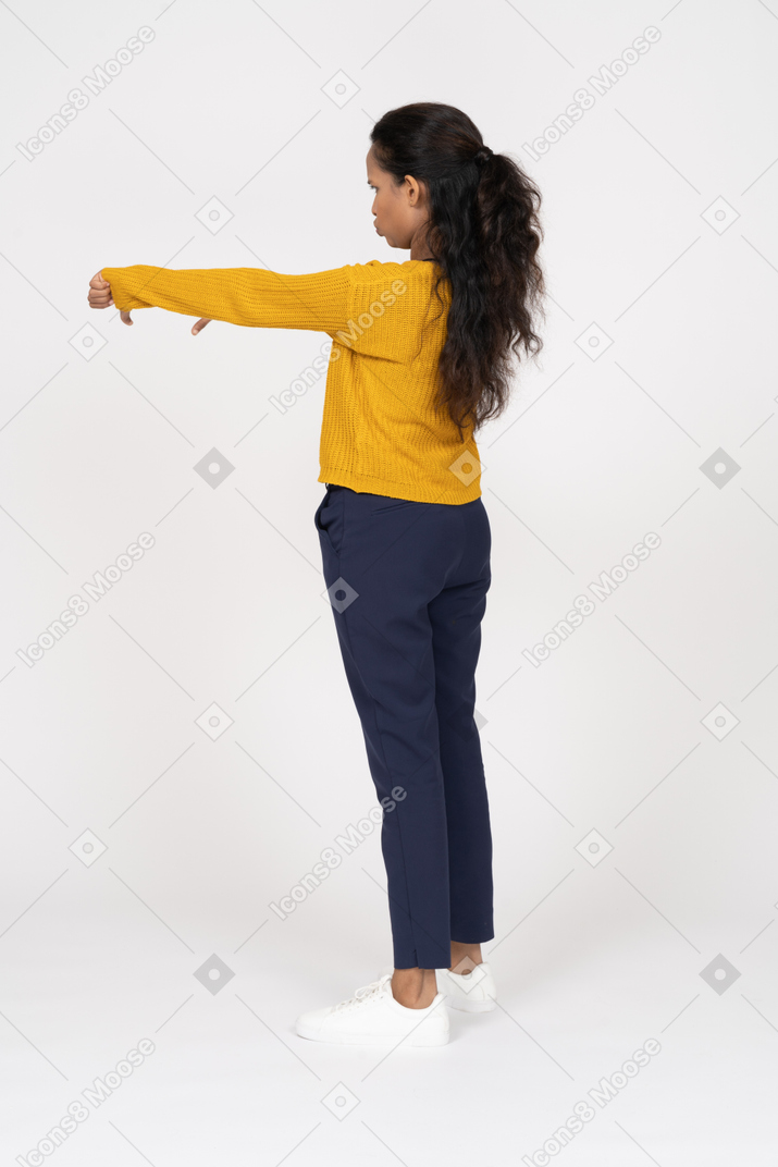 Side view of a girl in casual clothes showing thumbs down