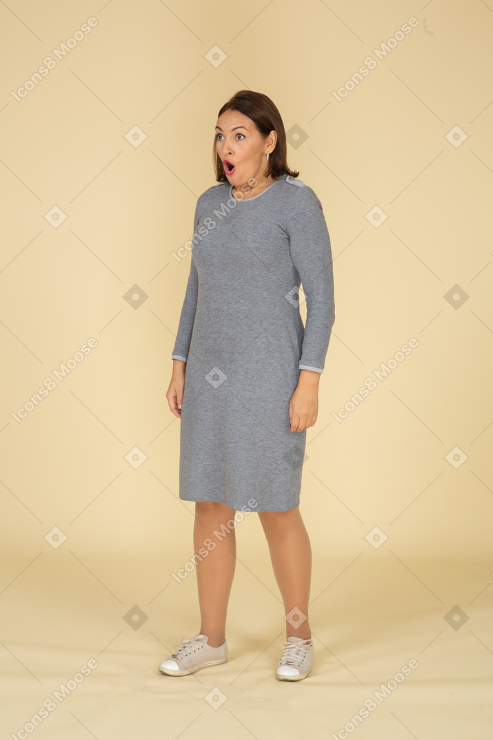 Impressed woman in grey dress
