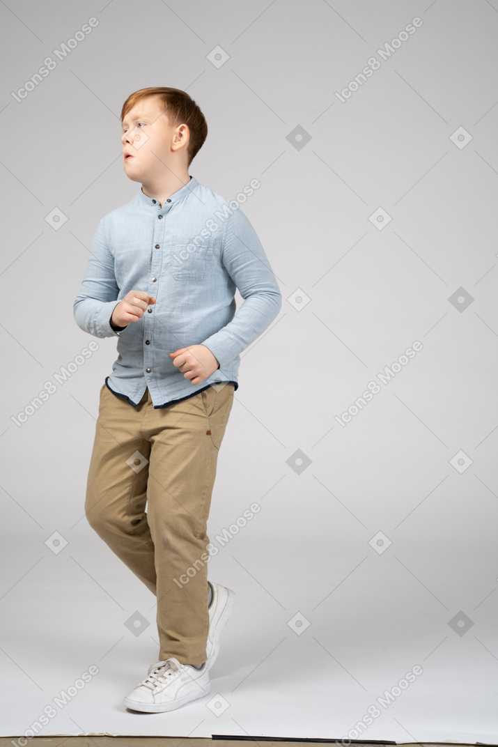 Boy in blue shirt running