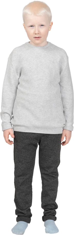 Front view of an offended kid boy looking at camera