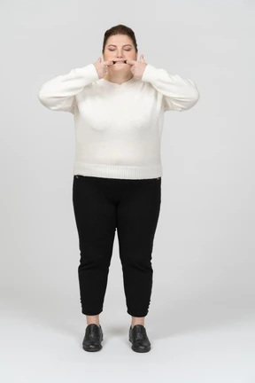 Plump woman in casual clothes making faces