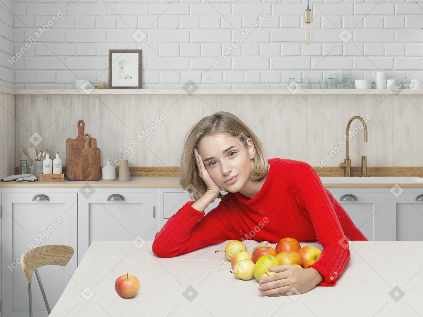 Young beautiful woman in red sweatshirt sitting in the kitchen
