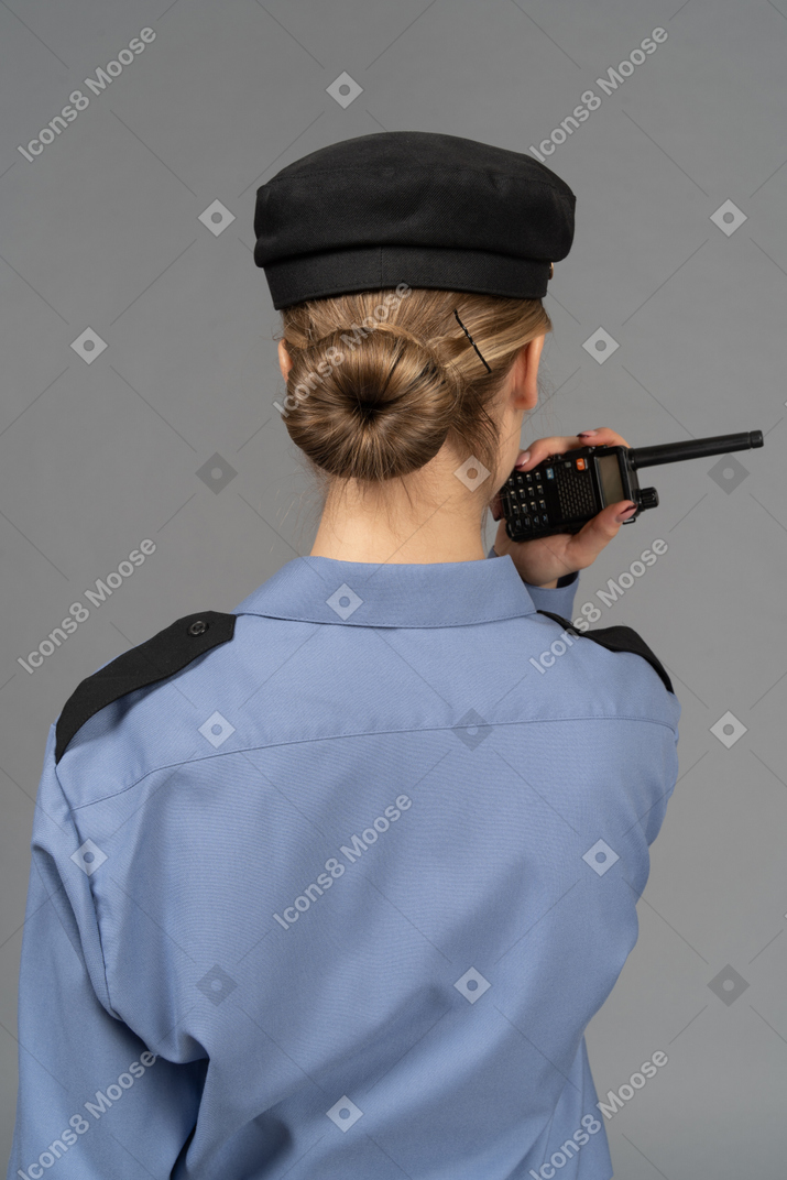 Female security guard holding a radio