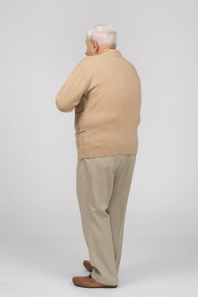 Rear view of a scared old man in casual clothes