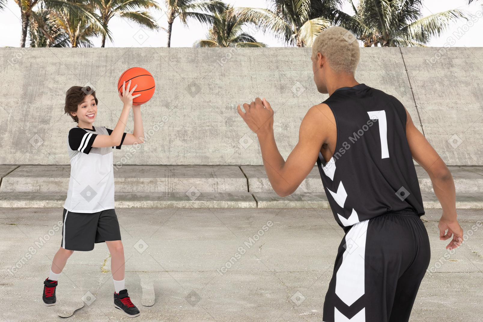 A young boy and a man playing basketball