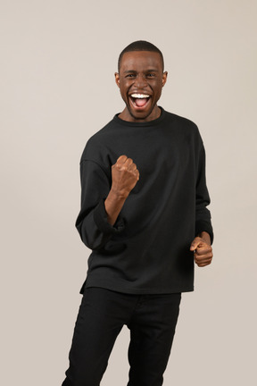 Front view of excited young man