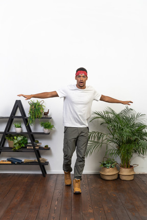 Good looking young man posing on the background of the apartment