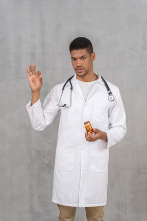 Young doctor holding a pill