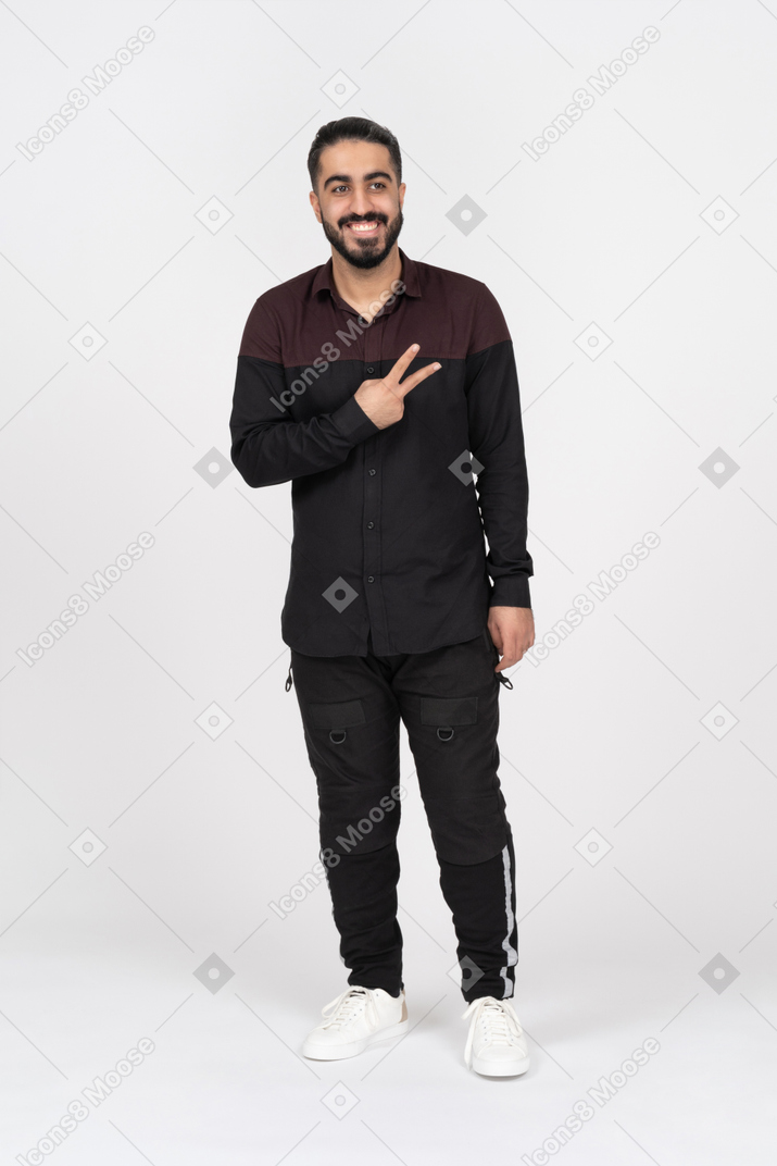 Smiling man showing peace sign