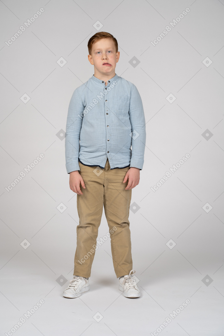 Front view of a boy making faces and looking at camera