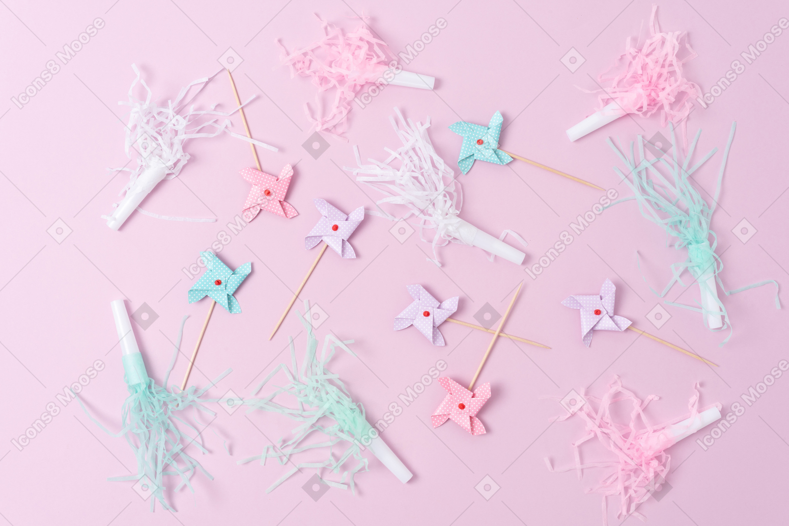 Pastel pinwheel and party horns on a pink background