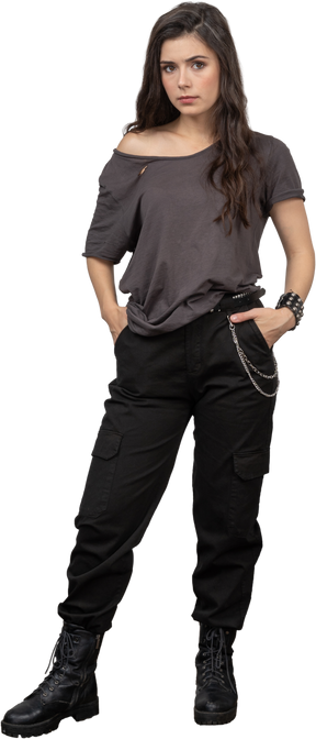 Front view of a female rocker putting hands in pockets while looking at camera