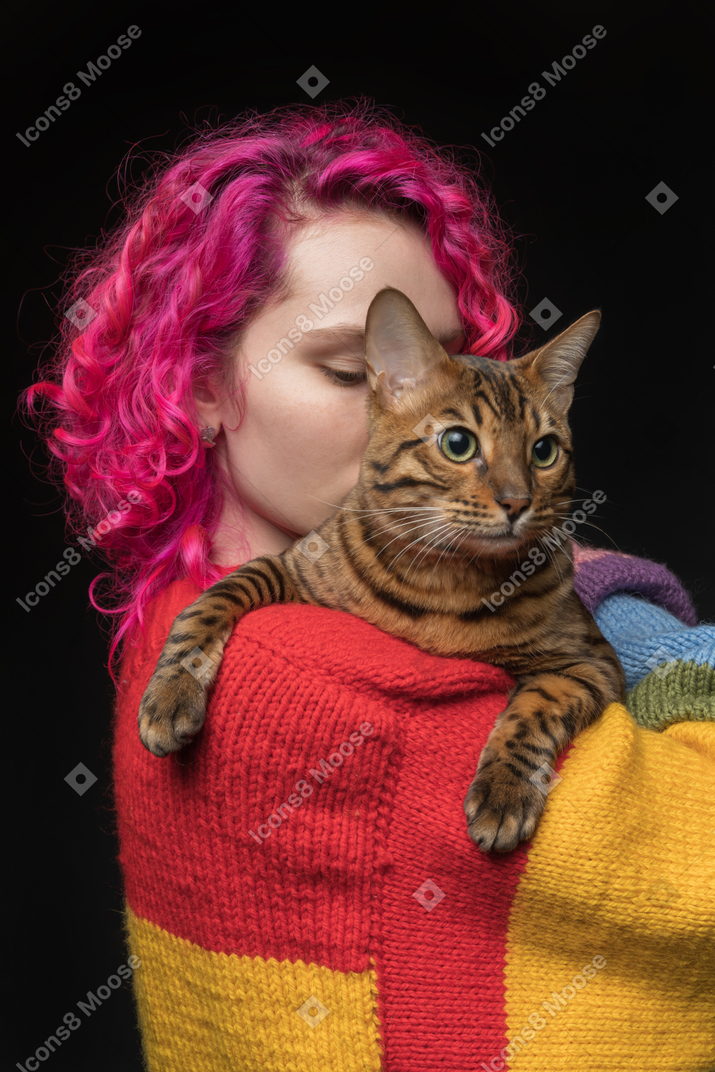 A bengal cat on the shoulder of its owner