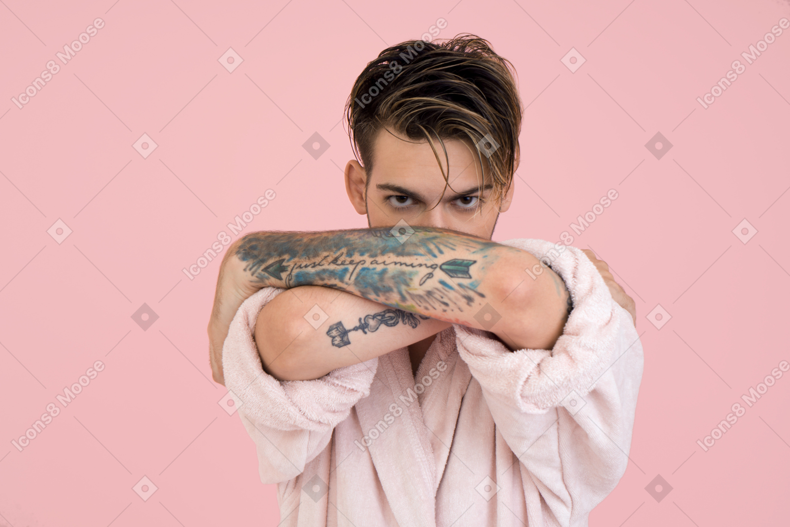 Good looking young man with tattoed arm
