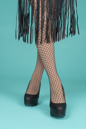 Front view of legs in fishnets and high heels