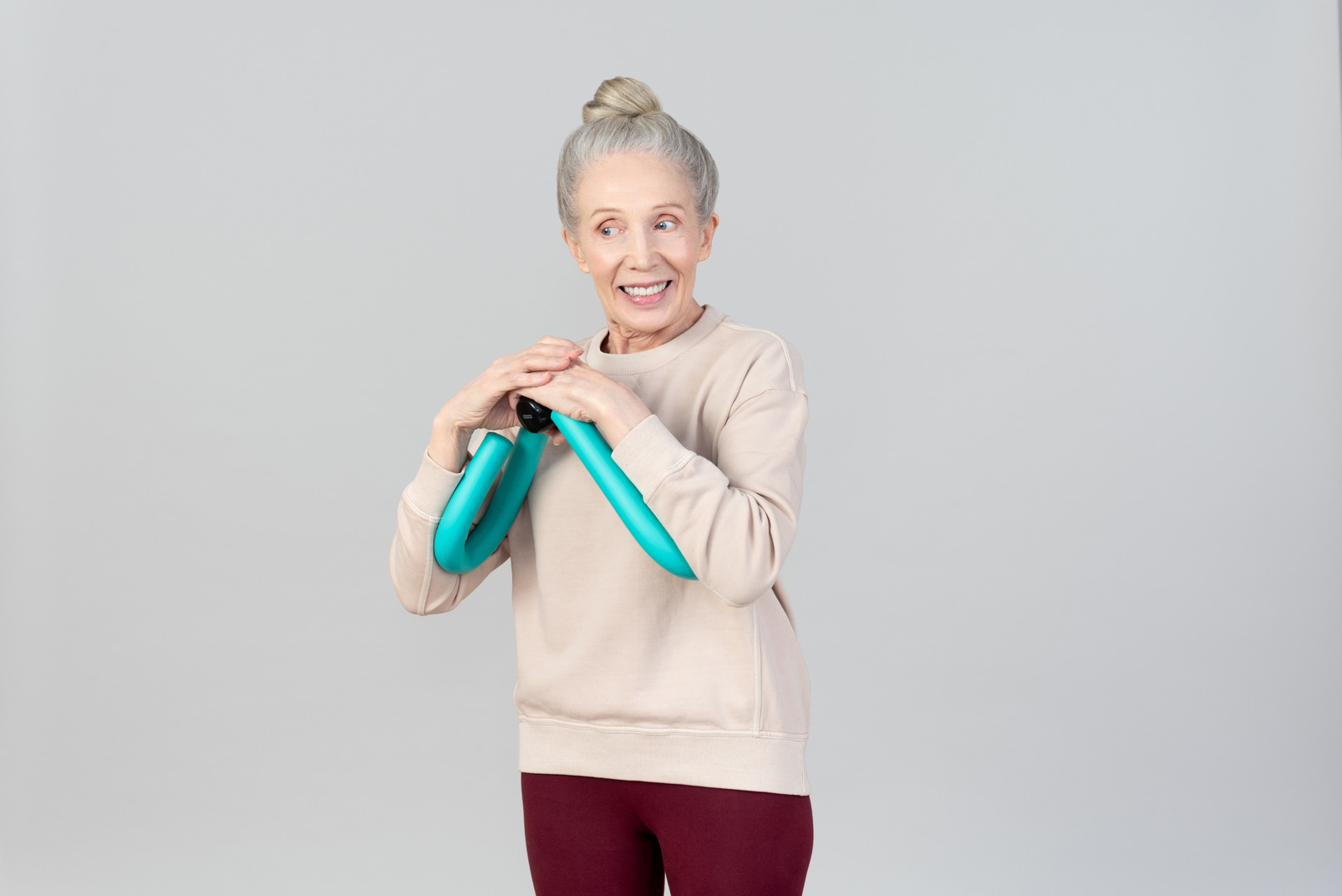 Smiling old woman using expander