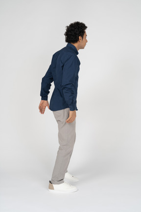 Side view of a man in casual clothes gesturing