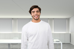 A man in a white shirt standing in a room