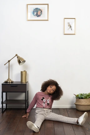 Cute girl kid posing on the apartments background