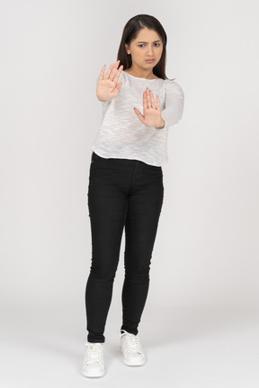 Front view of a young indian female in casual clothing outstretching arms