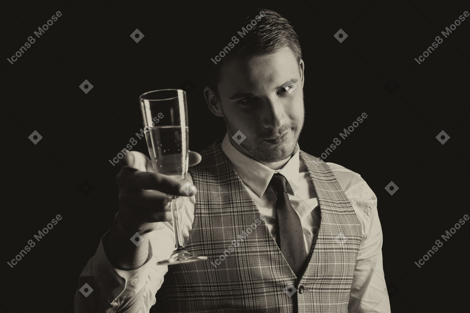 Séduisant jeune homme soulevant une coupe de champagne